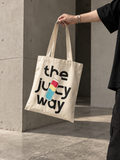 The Juicy Way tote bag carried by hand